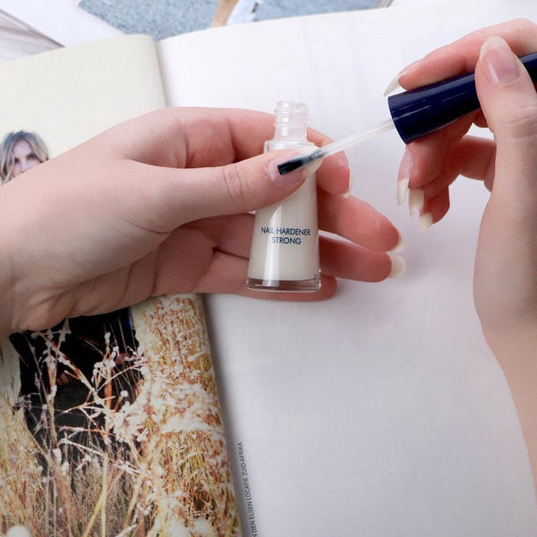 Herome Nail Hardener Strong applied to fingernails with a brush